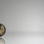 통장 잔고와 마음 건강의 상관관계, 재정적 웰니스 a close up of a coin on a reflective surface