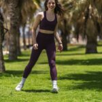 집콕 시대, ‘워킹 운동’이 만드는 건강한 변화…일상 속 실천법은? woman in black tank top and purple leggings running on green grass field during daytime