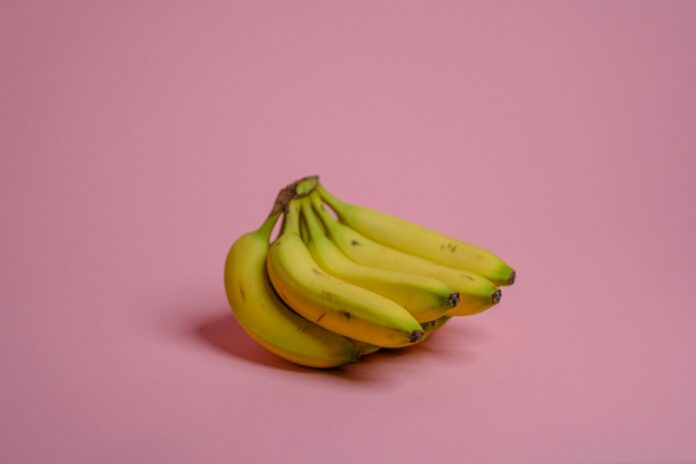 Photo by John Matychuk yellow banana fruit on pink surface
