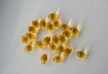 “내 몸에 맞게, 똑똑하게 챙기는 영양 & 보충제 활용법” a pile of fish oil capsules sitting on top of a table