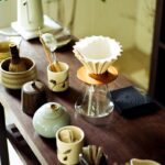 일상 속에서 실천하는 웰니스 문화, 건강한 삶의 새로운 흐름 Various tea ceremony utensils arranged on a wooden table.