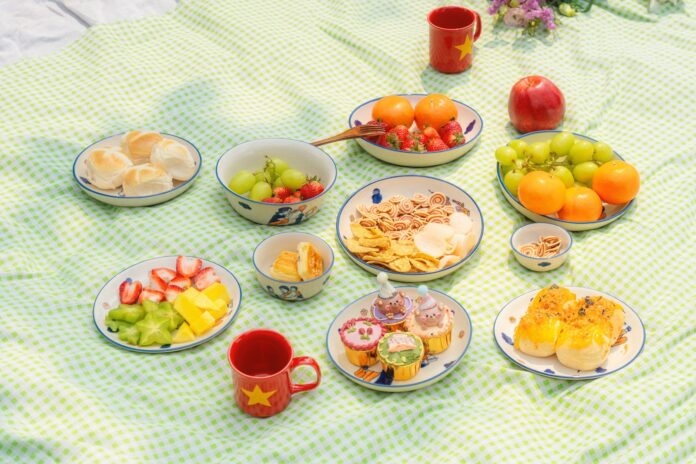 A picnic spread with various fruits and pastries.
