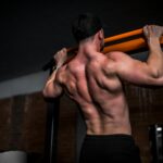 근육 건강, 일상 속 작은 실천이 만든다 topless man in black shorts holding orange bar