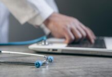 “AI, 우리 집 건강 지킴이로”…일상에 녹아든 스마트 건강 관리법 Doctor typing on a laptop with a stethoscope nearby.